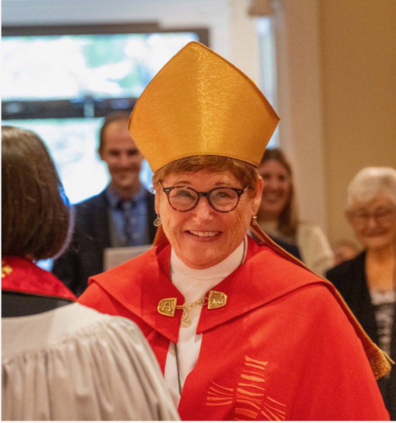 Bishop Ritonia in a red chasuble and gold mitre at her consecration