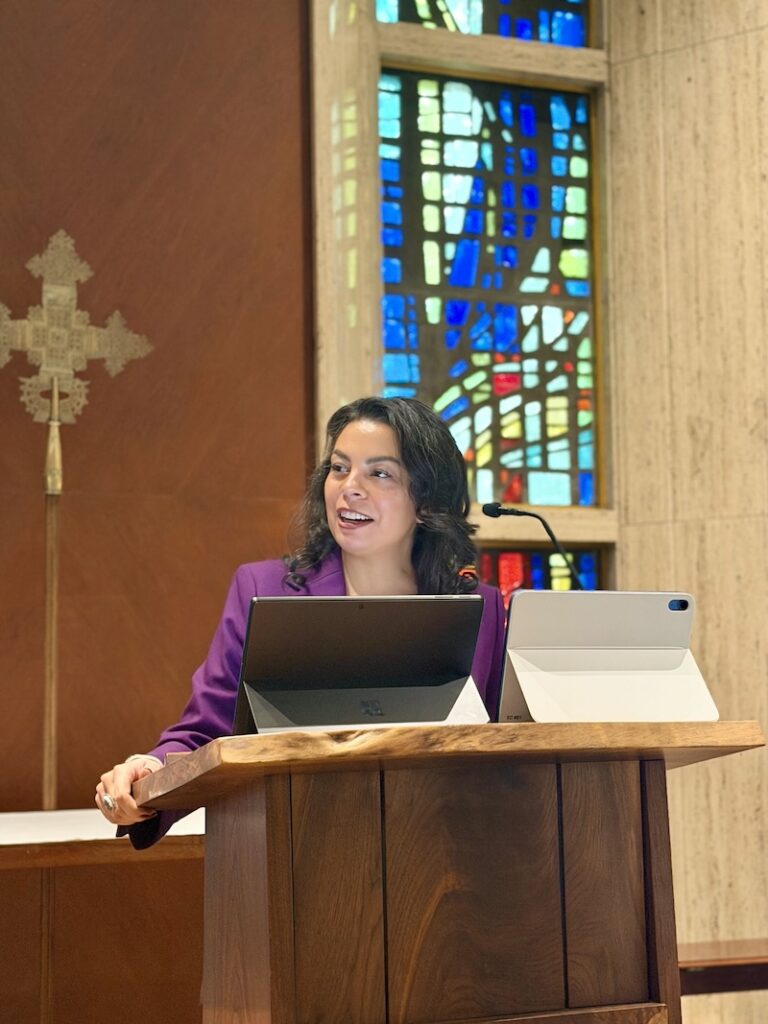 Julia Ayala Harris, President of the House of Deputies, stands at the lecture in the chapel at 815.