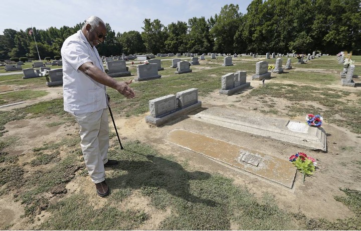 In this 2018 photo, Larry Monk stands where his father was buried at Elmwood Cemetery in Goldsboro, North Carolina. Flooding unearthed his father's vault and many other graves at the cemetery following Hurricane Matthew. (Photo by Gerry Broome)