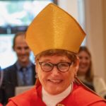 Bishop Ritonia, wearing a gold mitre and red cassock, at her consecration
