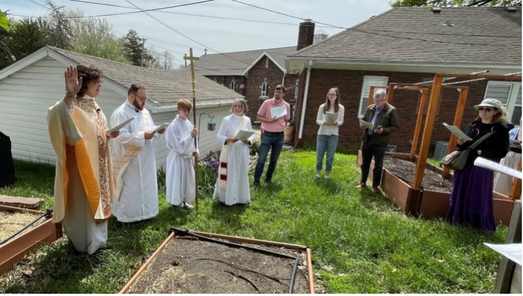 Rogation procession and priest bless garden boxes at Church of the Resurrection, Omaha, Nebraska.